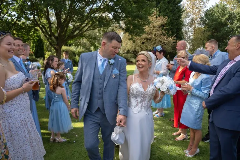 Confetti as the newlyweds walk through their guests