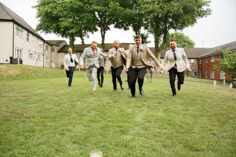 The wedding party crossing the grounds
