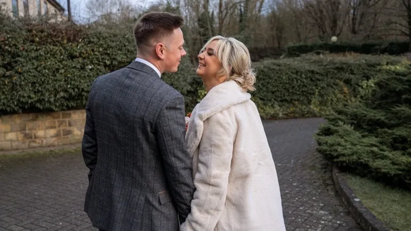Bride and groom share their first dance surrounded by guests